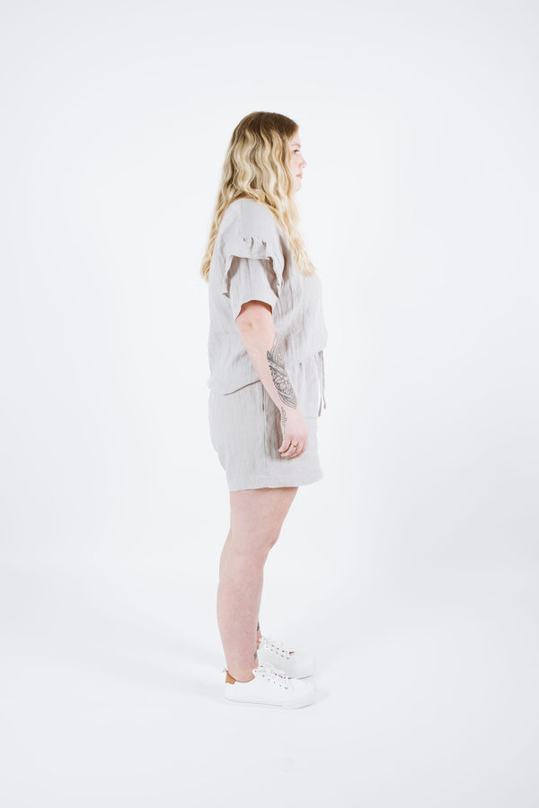 Cozy Solar Curve Tee/Sweater sewing pattern with ruffle sleeve detail, drop shoulders, and suitable for light to medium weight fabrics.