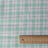 Summery Country Mint Check Linen Fabric with moss green and soft grey threads on a cream base, offering a smooth feel and gentle drape for comfortable wear.