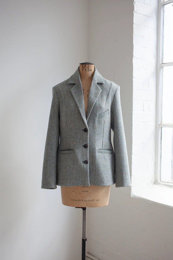 Gray blazer made using Naomi Blazer PDF Sewing Patternon a mannequin against a white wall with natural light.