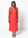 Woman wearing a red dress made using a style arc Esther woven dress sewing pattern with bow details on a white background