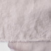 Close-up of light lilac-mauve inen fabric with visible texture