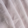 Close-up of light lilac-mauve inen fabric with visible texture