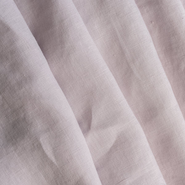 Close-up of light lilac-mauve inen fabric with visible texture