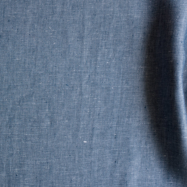 close up of Atlantic Twill linen fabric in denim-inspired blue with white flecks, twill weave, 100% linen, 225 GSM.