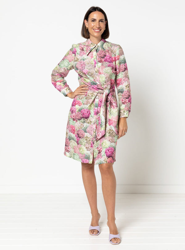 Woman wearing a floral dress on a made using Avon Woven Shirt and Dress sewing pattern white background