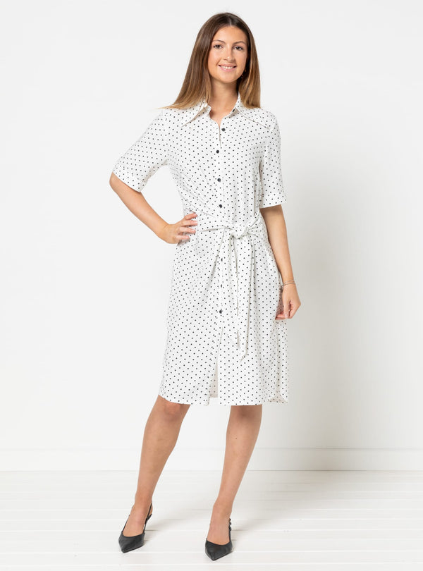 Woman wearing a white dress with black polka dots made using Avon Woven Shirt and Dress sewing patternon a white background