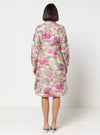 Woman wearing a floral dress made using Avon Woven Shirt and Dress sewing pattern against a white background
