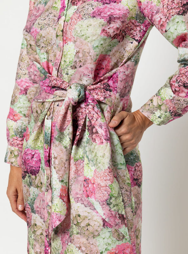 Floral patterned dress made using Avon Woven Shirt and Dress sewing patternwith a tie waist on a white background