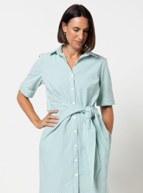 Woman wearing a light blue striped dress made using Avon Woven Shirt and Dress sewing pattern on a white background