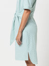 Light blue striped dress with a tie waistmade using Avon Woven Shirt and Dress sewing pattern on a white background