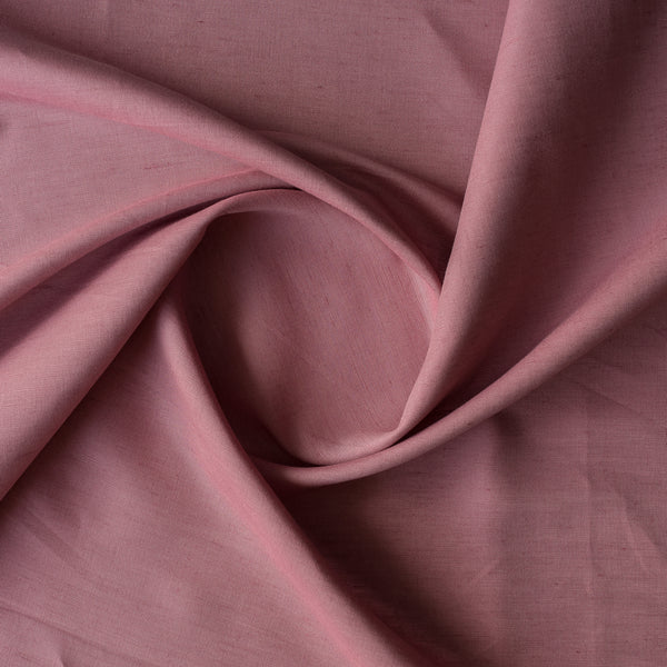Close-up of Blush Terra linen–cotton blend fabric in a muted dusky rose tone, plain weave texture, 136 GSM with folds