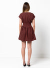 Woman wearing a burgundy dress made using Bronte Woven Dress sewing pattern on a white background