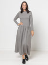Woman wearing a gray Carter Dress made using StyleArc pattern on a white background