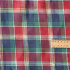 Plaid fabric with a ruler for scale- Festive Glen Tartan linen fabric – red, green and navy heritage tartan pattern, yarn-dyed linen for garments and festive sewing