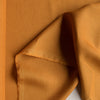 Saturated golden ochre 100% linen fabric with a luxurious smooth finish