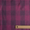 Purple checkered fabric with a wooden ruler for scale