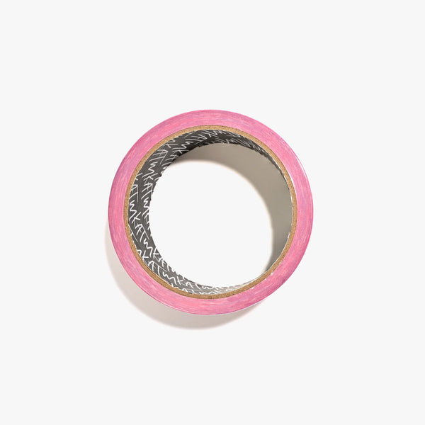 Roll of pink tape on a white background