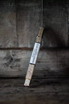 Wooden folding Merchant & Mills 1-metre wooden folding ruleron a wooden surface with a dark background