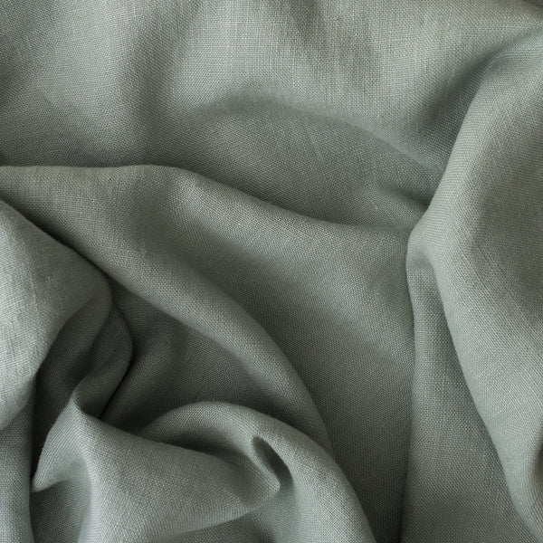 Close-up of Misty Sage extra wide 280cm 100% linen fabric 300gsm for jackets, aprons, cushions, curtains and structured home textiles with folds