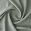 Close-up ofMisty Sage extra wide 280cm 100% linen fabric 300gsm for jackets, aprons, cushions, curtains and structured home textiles with folds