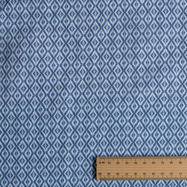 Blue diamond pattern fabric with a ruler for scale