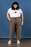Person wearing a white t-shirt and brown pants made using Sepia Pants and Shorts sewing patternagainst a blue background