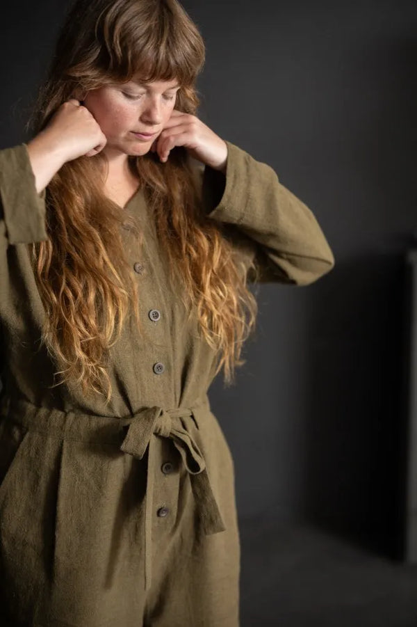 Woman wearing a green cassidy against a dark background