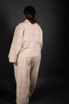 Person wearing a plaid outfit on a black background